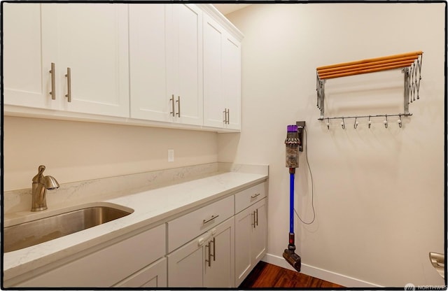 washroom with sink and dark wood-type flooring