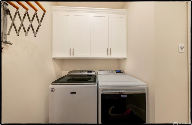 laundry area with cabinets and independent washer and dryer