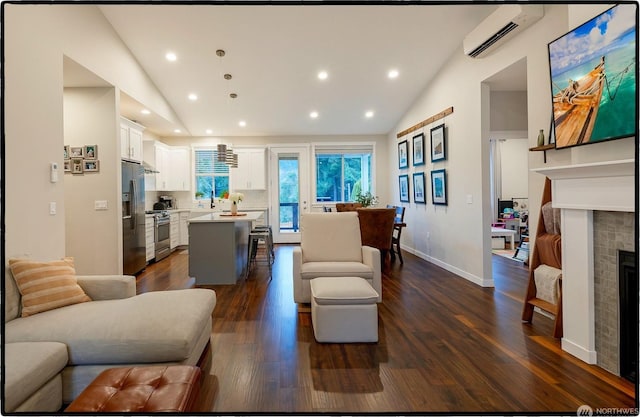 living room with lofted ceiling, a wall mounted air conditioner, and dark hardwood / wood-style flooring