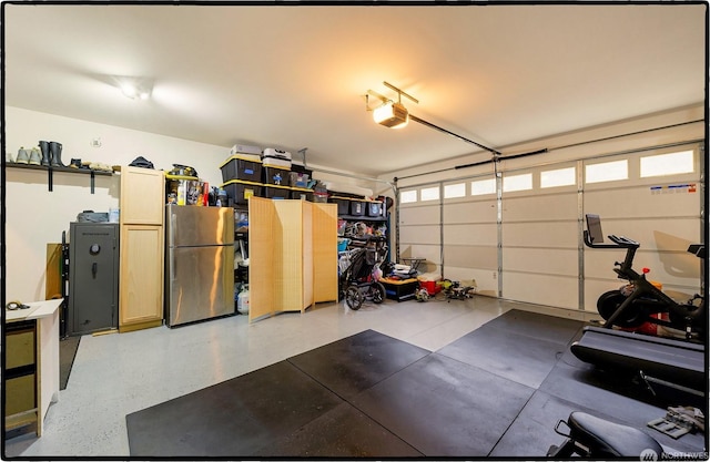 garage featuring a garage door opener and stainless steel fridge