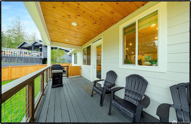 wooden terrace featuring area for grilling