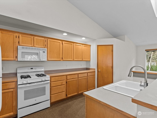 kitchen featuring lofted ceiling, sink, and white appliances