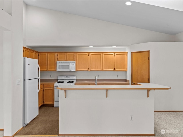 kitchen featuring vaulted ceiling, white appliances, a kitchen island with sink, and dark carpet