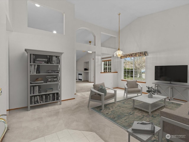 carpeted living room featuring high vaulted ceiling