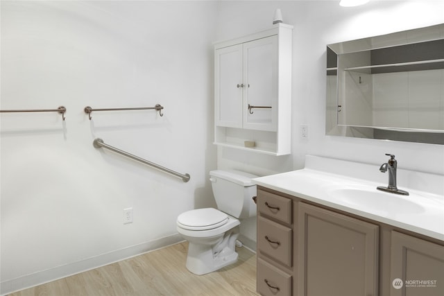 bathroom with vanity, wood-type flooring, a shower, and toilet