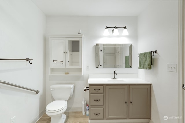 bathroom with vanity, hardwood / wood-style floors, and toilet