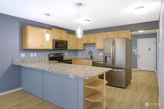 kitchen featuring appliances with stainless steel finishes, light brown cabinets, kitchen peninsula, and decorative light fixtures