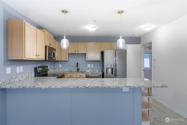 kitchen with pendant lighting, stainless steel appliances, kitchen peninsula, and light brown cabinets