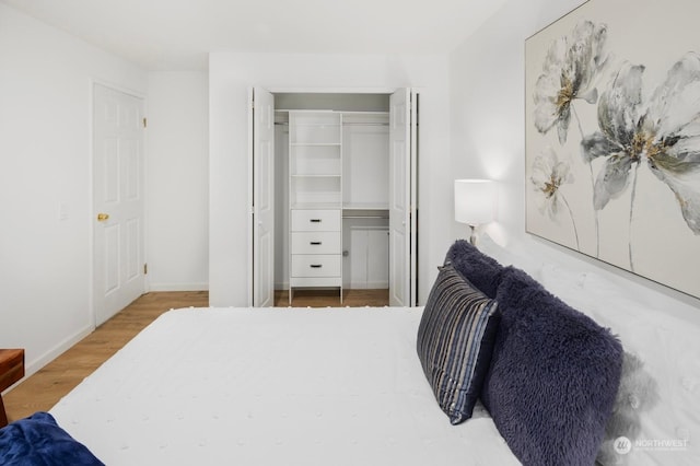 bedroom featuring hardwood / wood-style floors and a closet