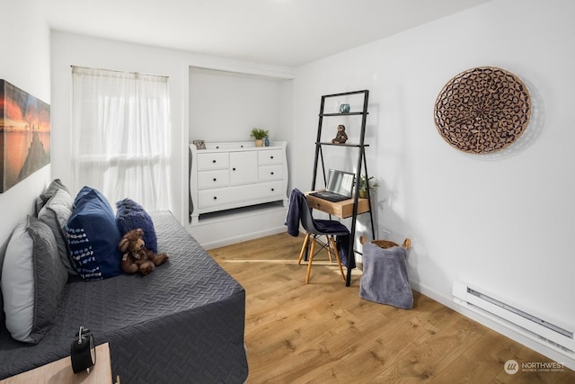 living area featuring baseboard heating and light wood-type flooring