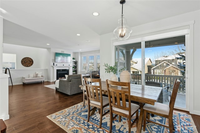 dining space featuring dark hardwood / wood-style floors and a chandelier