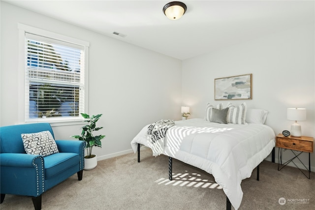 carpeted bedroom with visible vents and baseboards