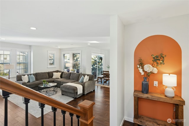 living area featuring baseboards, wood finished floors, and recessed lighting