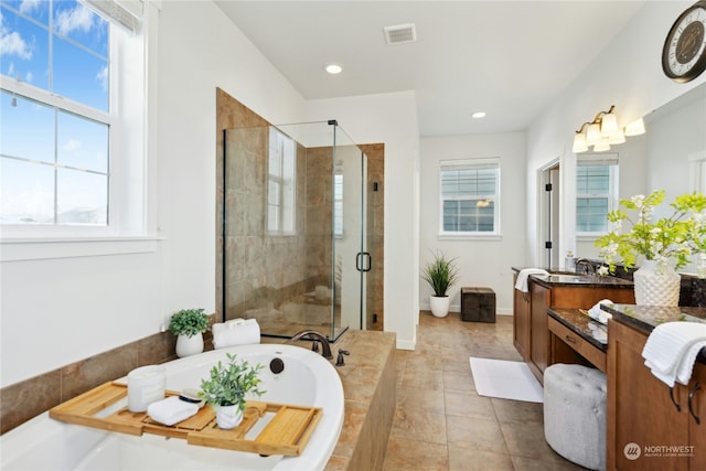 bathroom featuring vanity, plus walk in shower, and tile patterned flooring