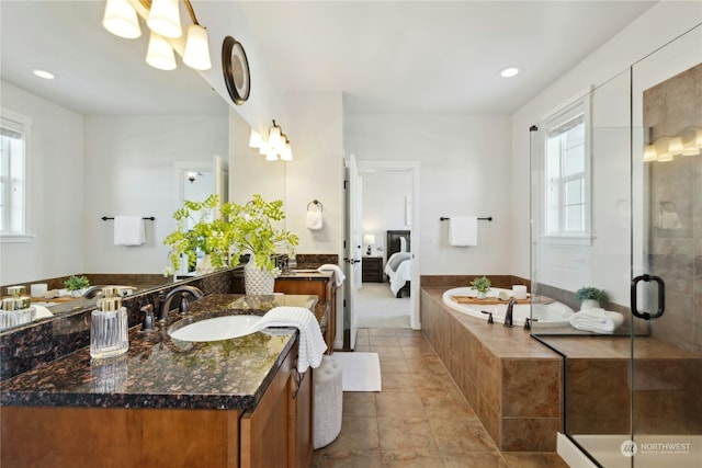 bathroom featuring vanity, independent shower and bath, and a wealth of natural light