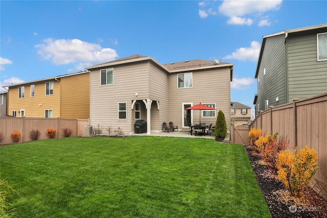 rear view of property with a yard, central AC, and a patio