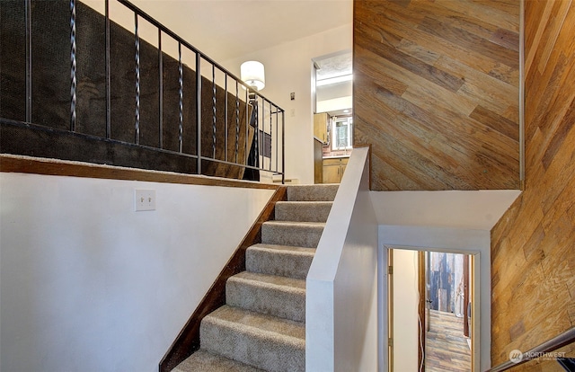 staircase with wooden walls