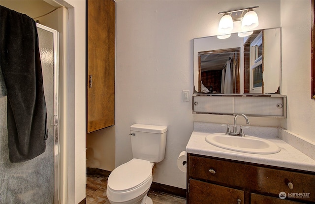 bathroom with vanity, toilet, and walk in shower