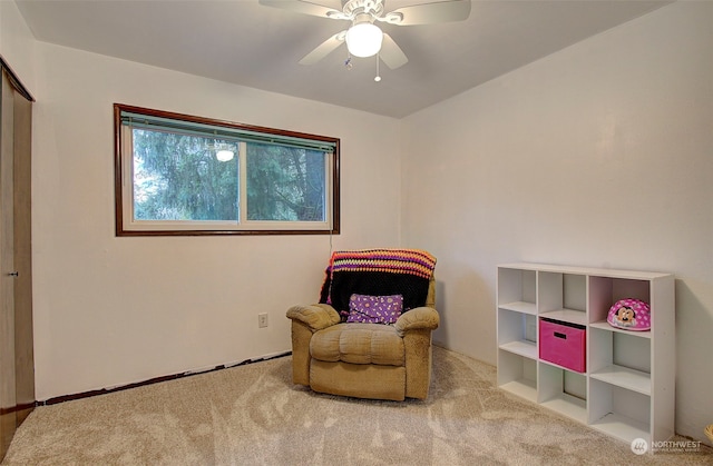 sitting room with carpet flooring and ceiling fan