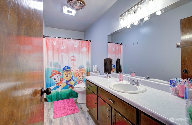 bathroom featuring hardwood / wood-style flooring, vanity, and toilet