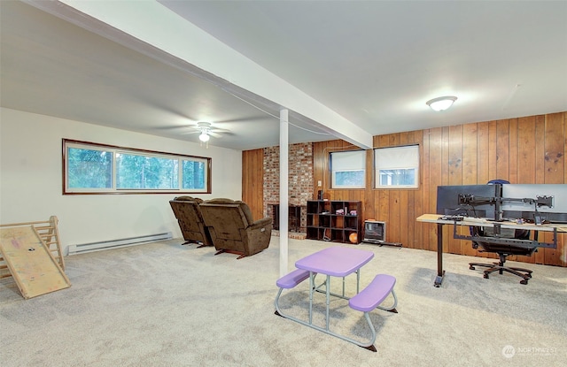 office space with light carpet, a baseboard heating unit, beam ceiling, and wood walls