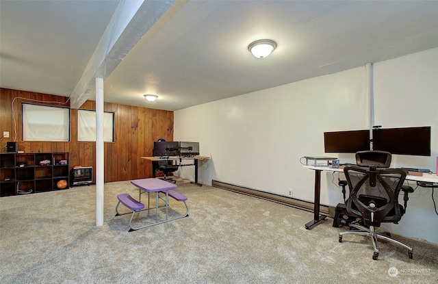 carpeted office space featuring baseboard heating and wood walls