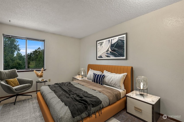 carpeted bedroom featuring a textured ceiling