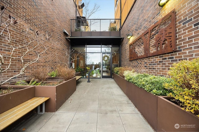 view of exterior entry with a balcony