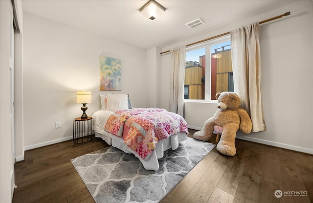 bedroom with dark wood-type flooring