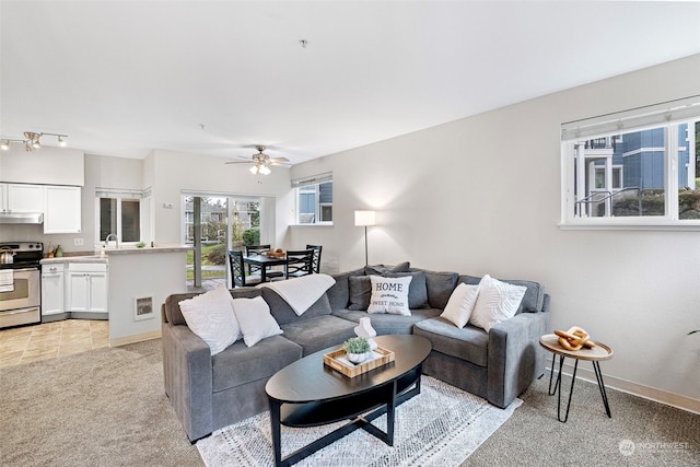 carpeted living room featuring ceiling fan