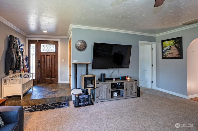 carpeted living room with ornamental molding and a textured ceiling