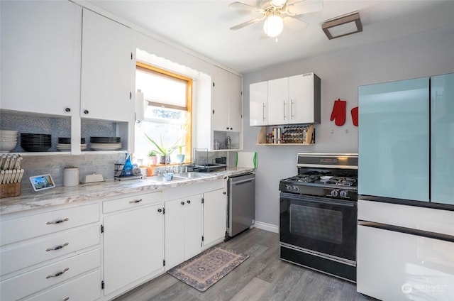 kitchen with tasteful backsplash, white cabinetry, dishwasher, black range with gas stovetop, and light hardwood / wood-style floors