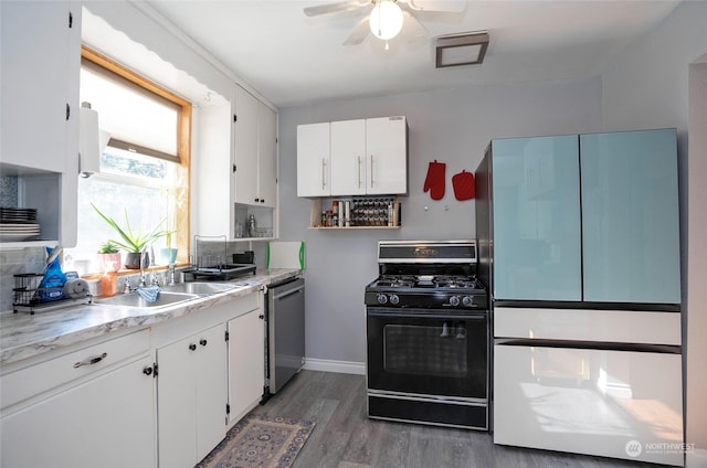 kitchen featuring black range with gas cooktop, white cabinets, sink, and dishwasher