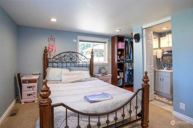 bedroom featuring carpet and connected bathroom