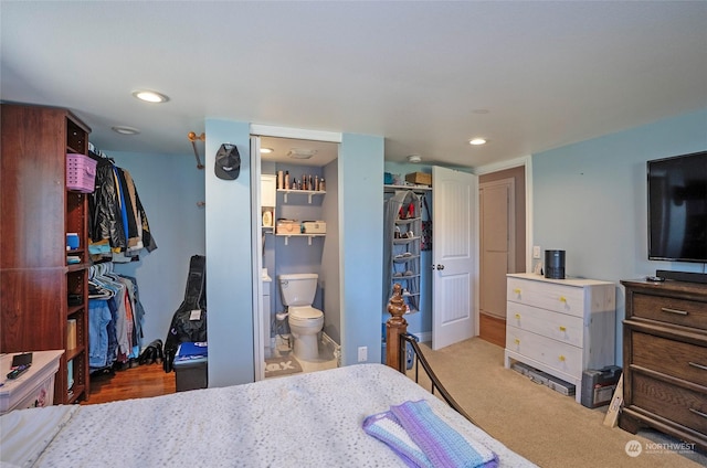 carpeted bedroom with ensuite bathroom