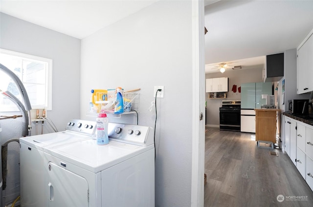 washroom with dark wood-type flooring and washing machine and clothes dryer