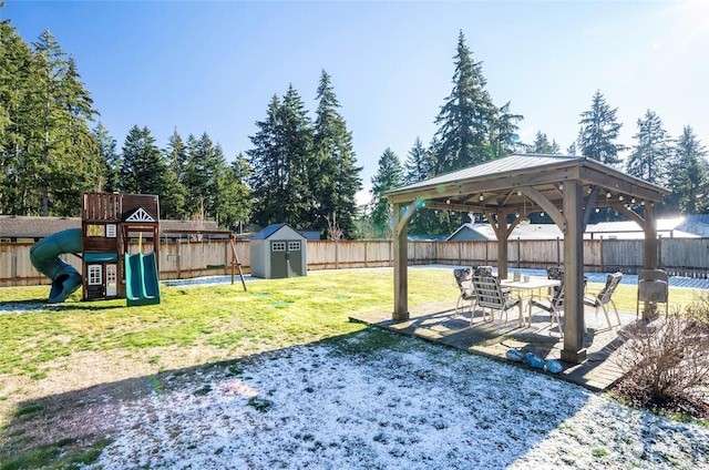 view of yard with a gazebo, a storage unit, a playground, and a patio