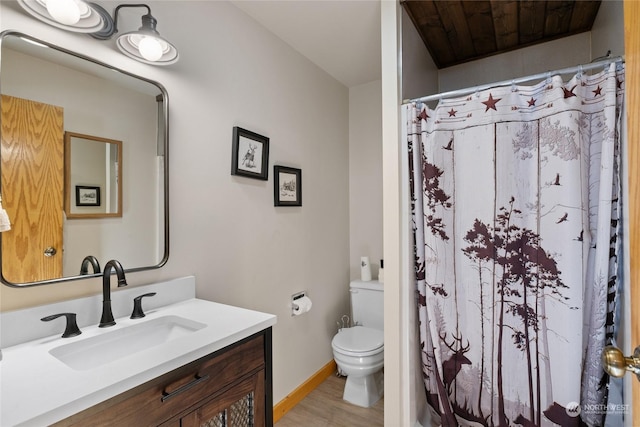 bathroom featuring a shower with curtain, vanity, wood-type flooring, and toilet