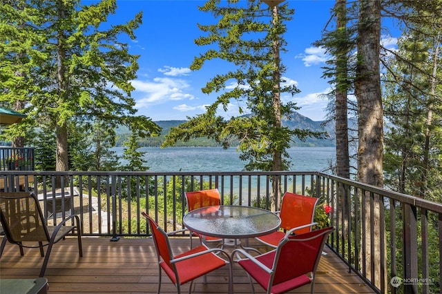 wooden terrace with a water and mountain view