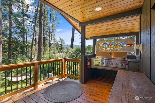 wooden terrace featuring area for grilling