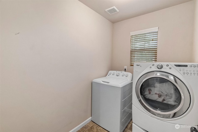 clothes washing area featuring laundry area, independent washer and dryer, visible vents, and baseboards