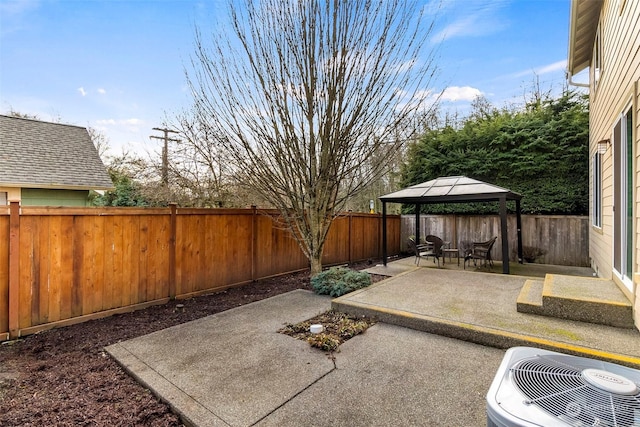 view of patio / terrace with central air condition unit, a fenced backyard, and a gazebo