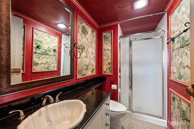 bathroom with an enclosed shower, vanity, ornamental molding, and toilet