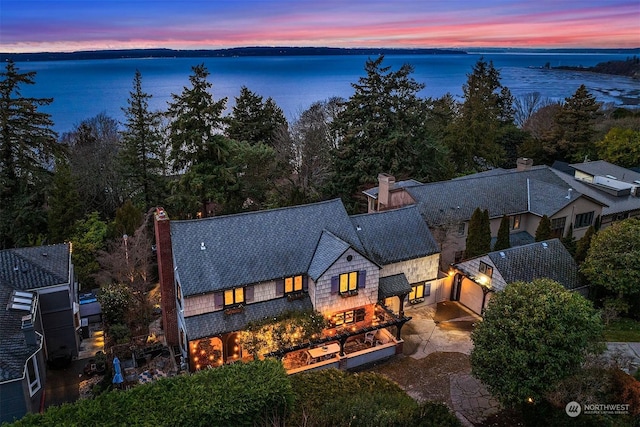 aerial view at dusk with a water view