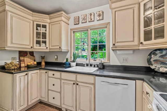 kitchen with sink, white electric stove, cream cabinets, and stainless steel dishwasher