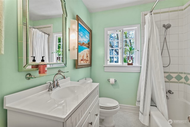 full bathroom featuring vanity, toilet, tile patterned flooring, and shower / bath combo with shower curtain