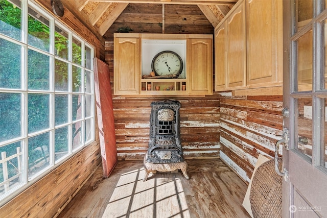 interior space with log walls and wood-type flooring