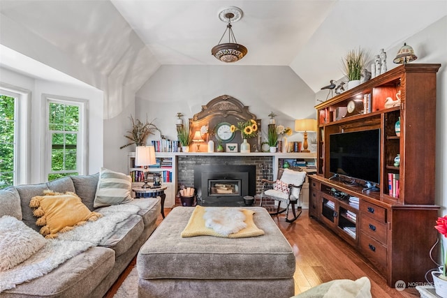 living room with lofted ceiling and light hardwood / wood-style flooring