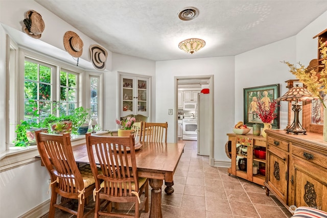 dining room featuring a textured ceiling