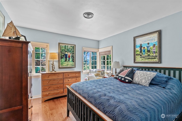 bedroom featuring multiple windows and light hardwood / wood-style floors